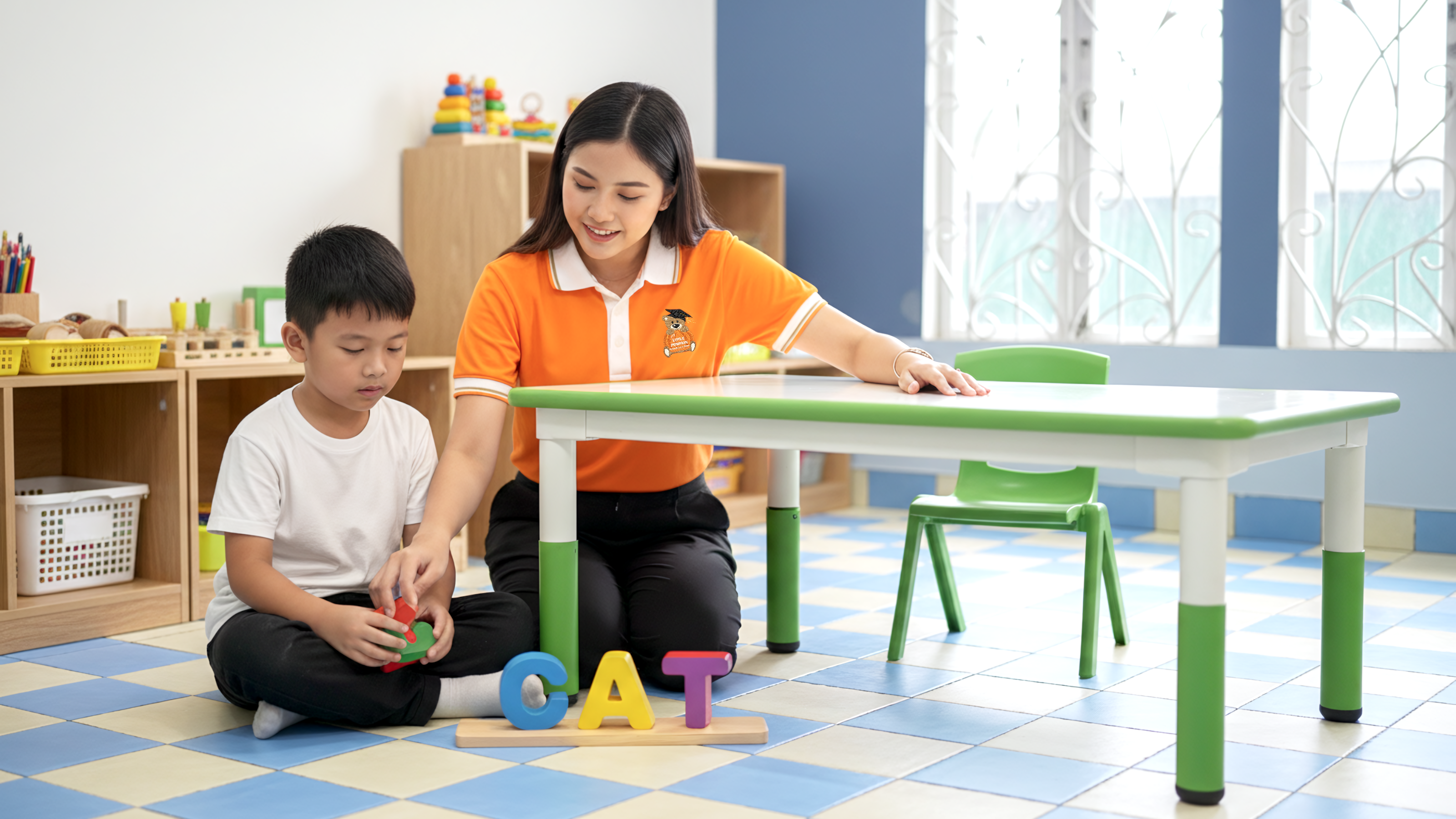 A supportive teacher at My Little Pumpkin Special Education School guides a young student using colorful, tactile letter blocks to form words, demonstrating a multisensory approach for dyslexia.