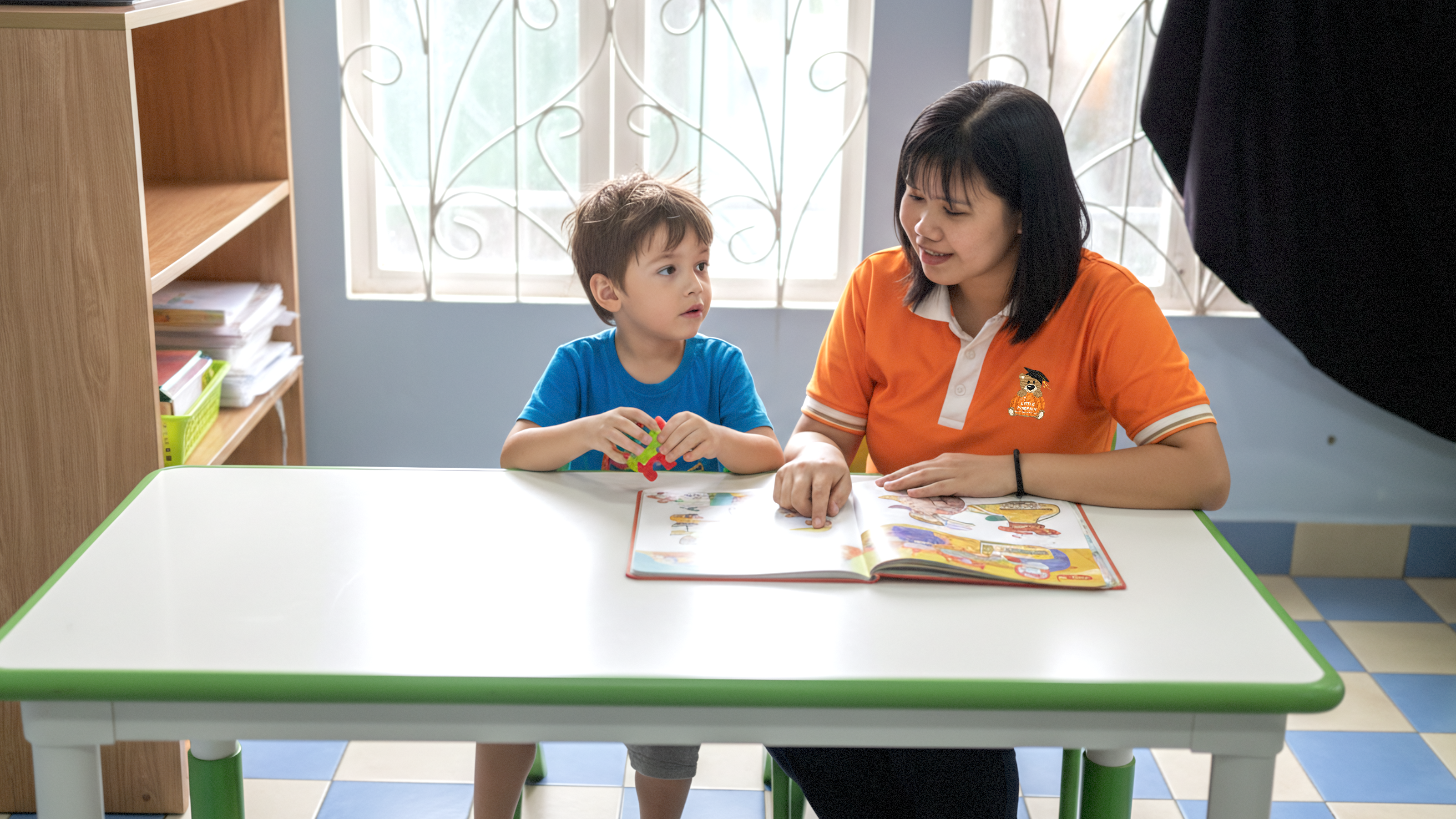 A teacher observing a child's focus during a reading activity