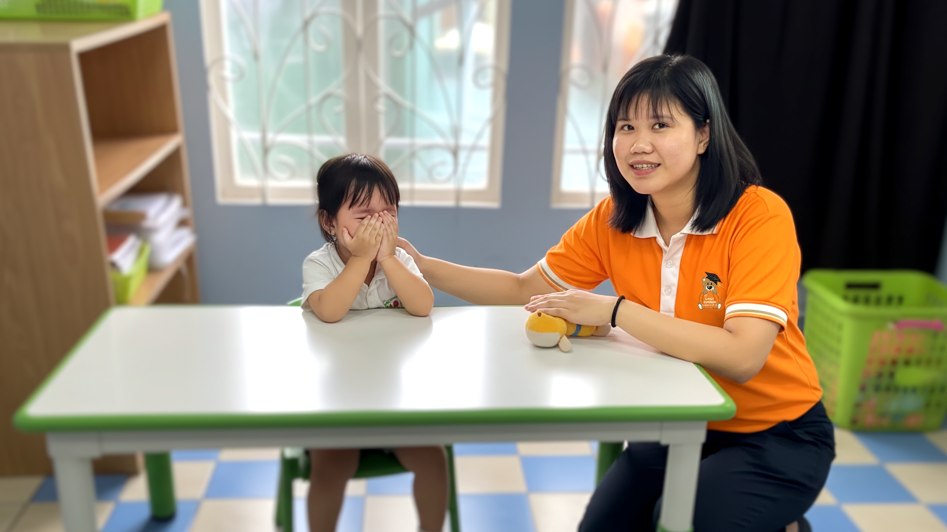 A teacher at My Little Pumpkin Special Education School helping a child manage their emotions in a calm classroom setting.